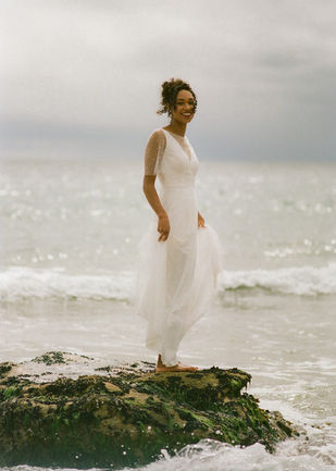 Pearl wedding dress with a V bodice, tulle overlay, and pearl embellishments