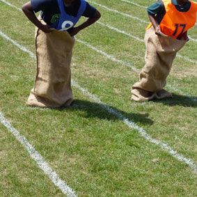 sack race; children;cub scouts;grass;track;track lines;competition