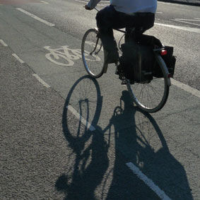 Cyclist;cycle lane;strong shadow;anonymous