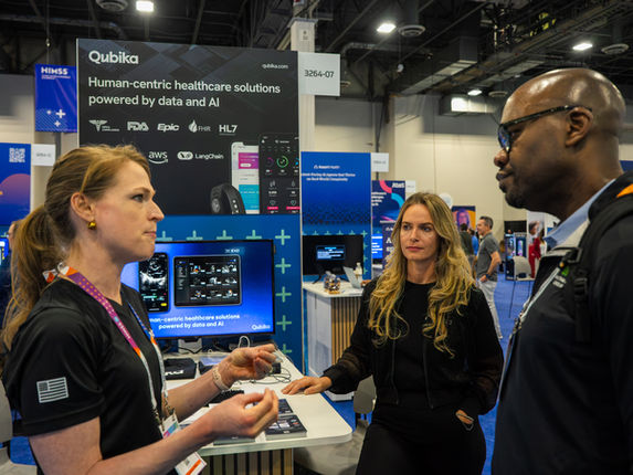 Team members from Qubika talk with prospective clients at the HIMSS conference in Las Vegas