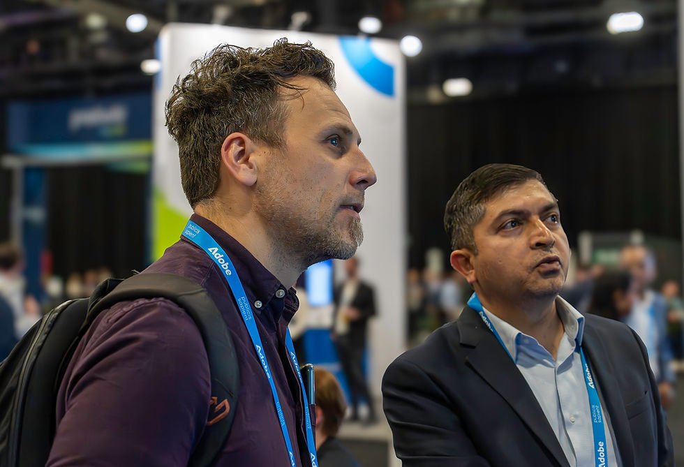 Two men go over a product demo at Adobe Summit in Las Vegas, NV
