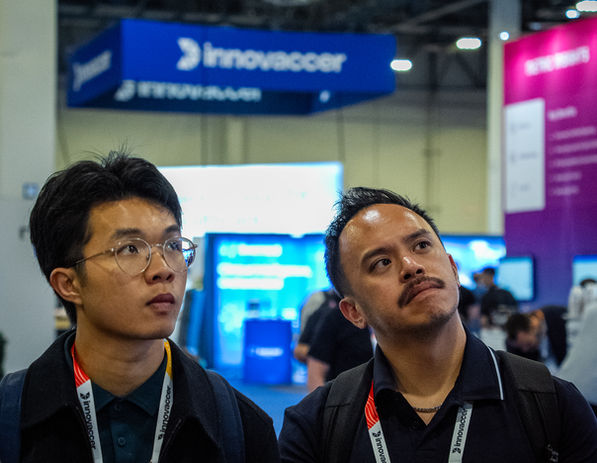 Two men stand spellbound by a product demo at HIMSS26 in Las Vegas