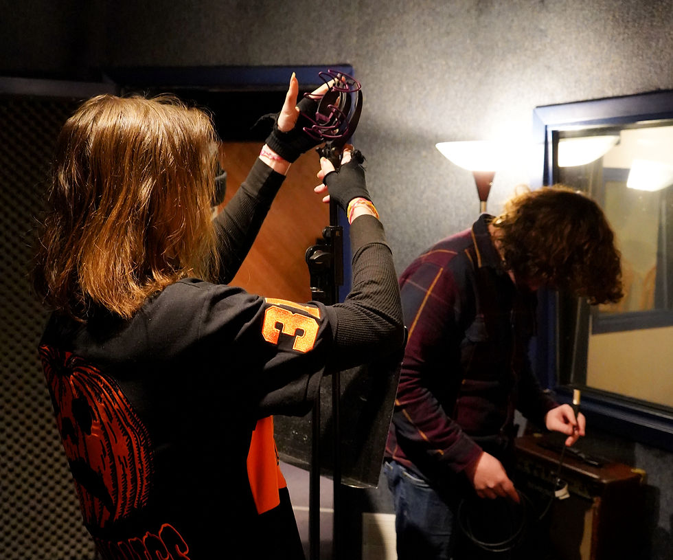 Student placing a mic clip on a stand