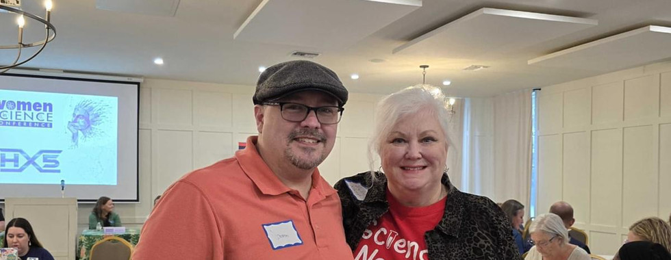 Smiling man and woman at science event