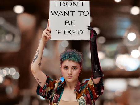Person holding sign that reads "I DON'T WANT TO BE FIXED" representing ADHD partner perspective in relationships