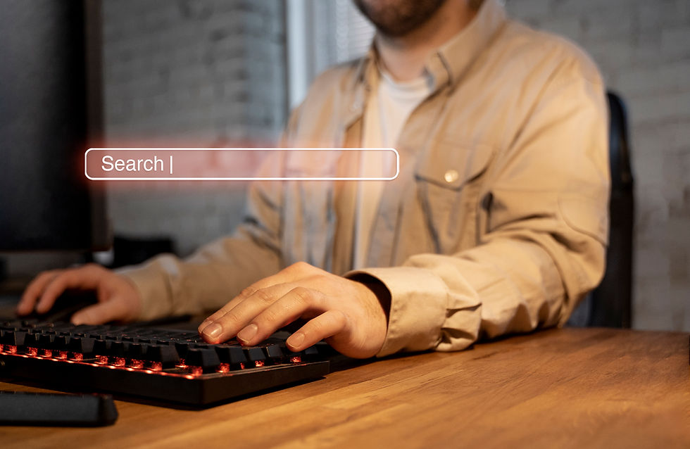 A person in a beige shirt types on a backlit keyboard. A transparent search bar overlay is visible, creating a focused tech atmosphere.