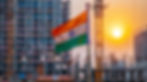 Indian flag waving in front of a high-rise construction site, with a vibrant sunset illuminating the sky, creating a warm glow.