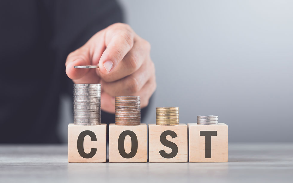 Hand placing a coin on stacked coins above blocks spelling COST on a gray background.
