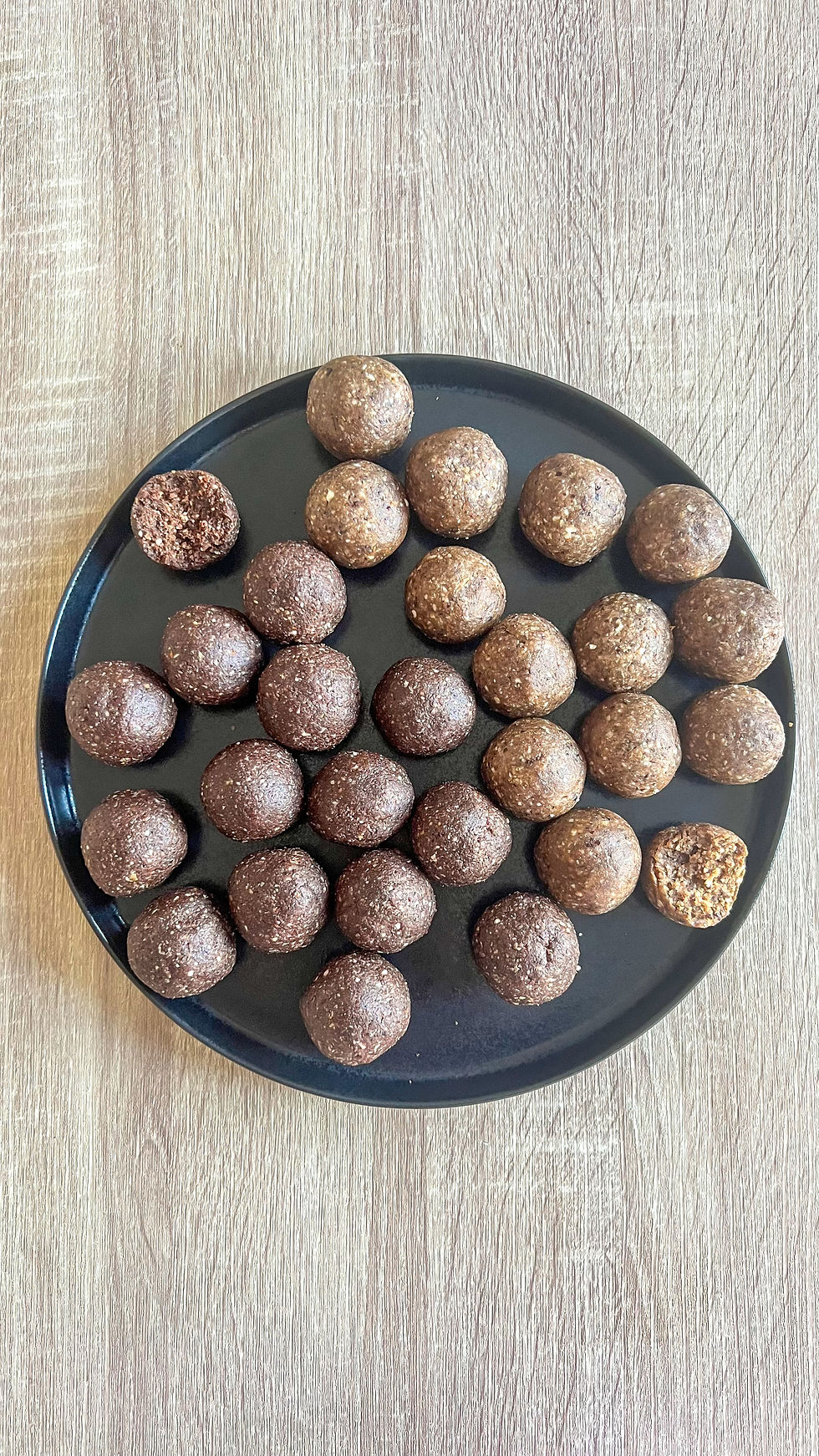Seed cycling energy balls σε μαύρο πιάτο