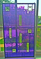 Rectangular stained glass piece using purple and clear glass in a decorative design.