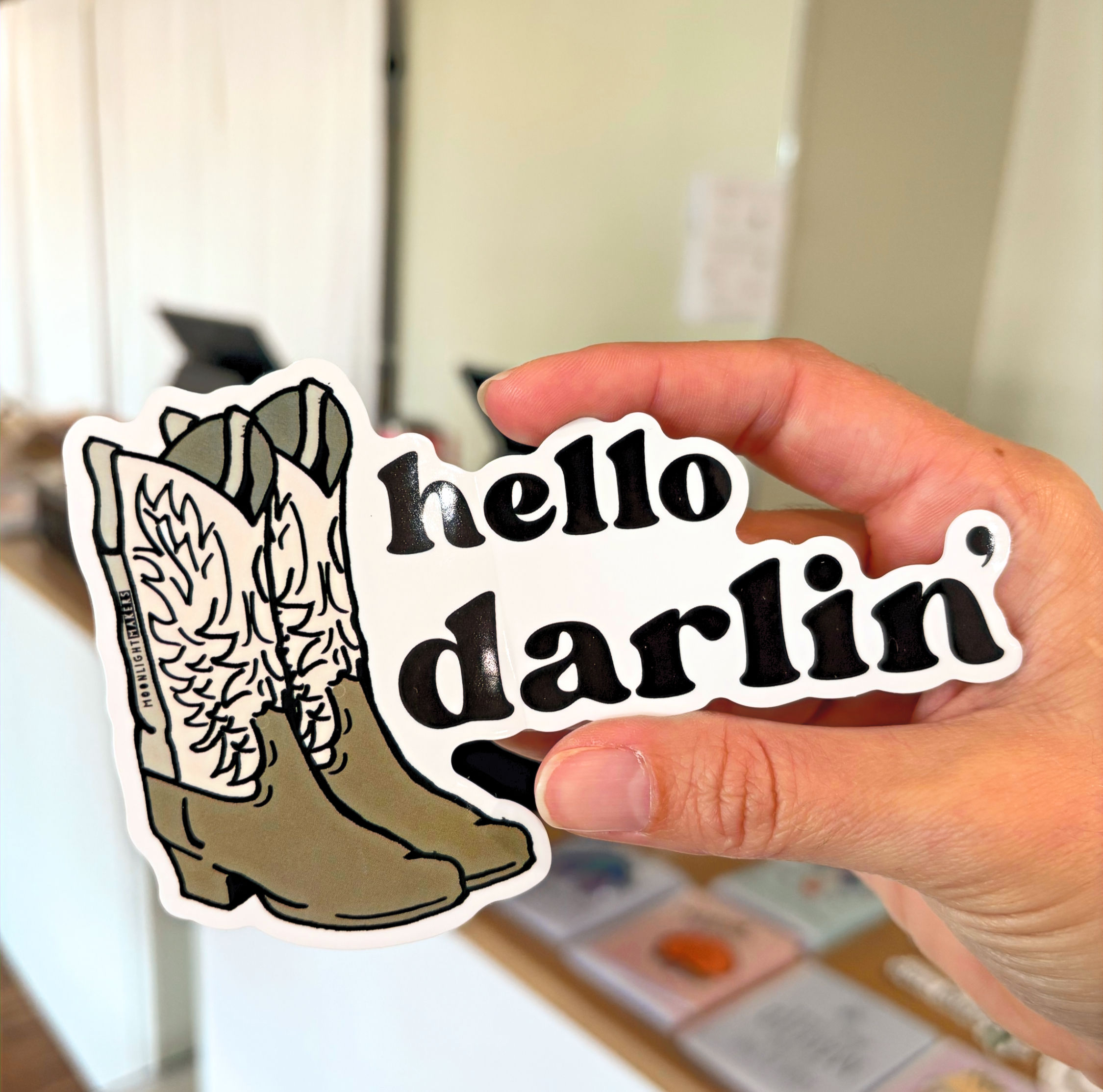 Sticker of cowboy boots with "hello darlin" saying