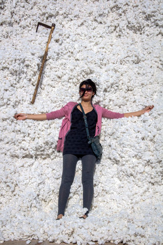 a woman laying on a pile of white cotton