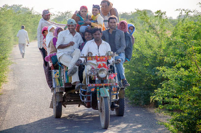 a large group of people are riding on the back of a motorcycle