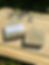 Two citronella soaps laying on a wood cutting board. One soap is face up with a label and the other is unlabeled.