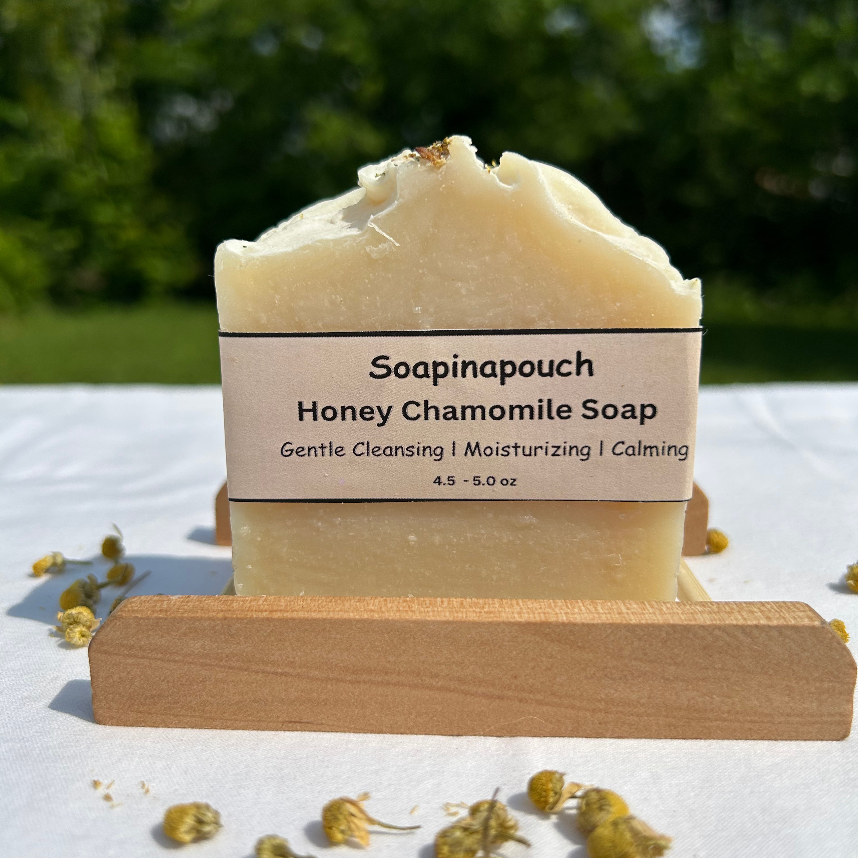 Gentle chamomile honey soap bar topped with chamomile buds, handcrafted with natural oils and ideal for soothing sensitive or