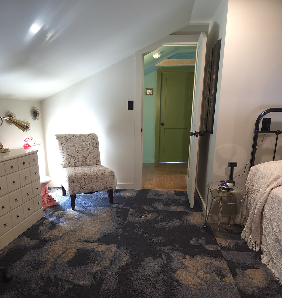 Eye-level view of a cozy living room with slanted ceilings and built-in shelves