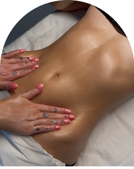 Massaging a clients abdomen as part of a stomach focused lymphatic drainage massage