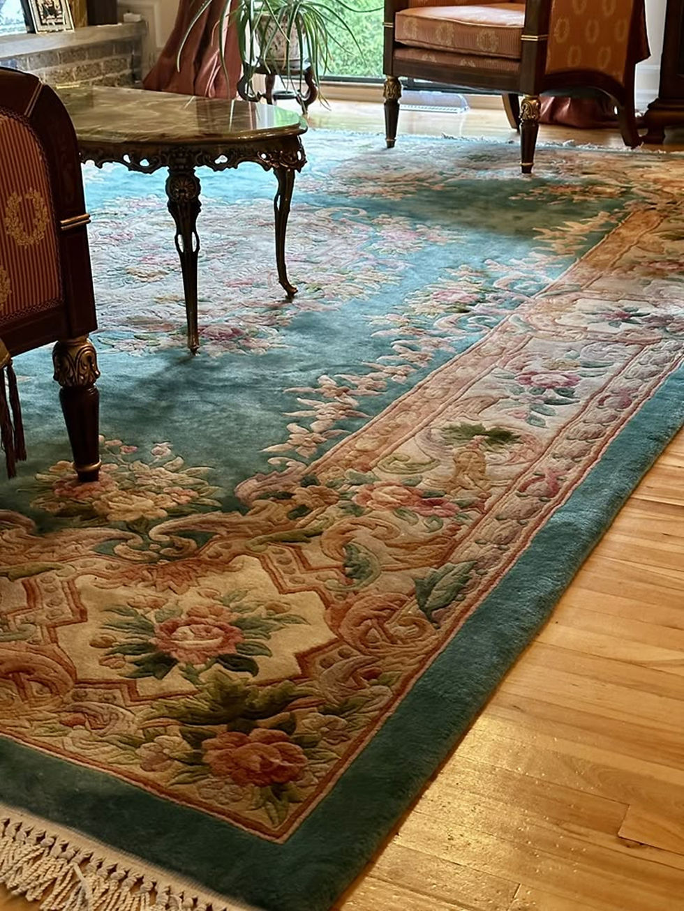 Persian rug and silk cushions enhancing the warmth of a traditionally styled room