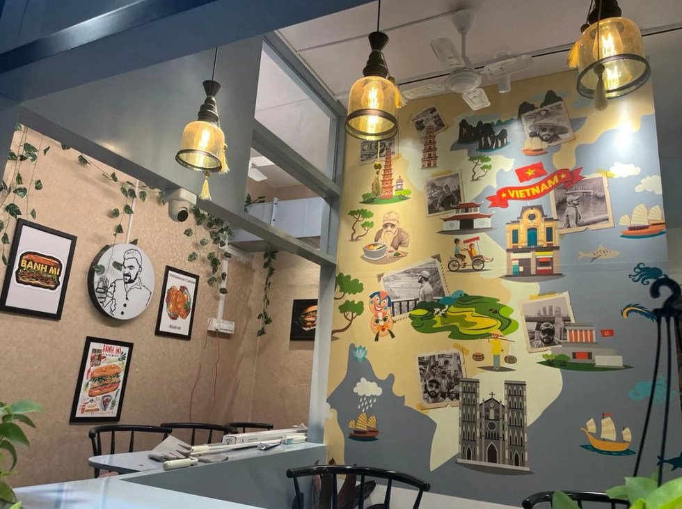 Interior view of Dear Banh Mi café featuring a modern, minimalist design with cozy seating, natural lighting, and earthy tones, creating a warm and inviting ambiance for guests.