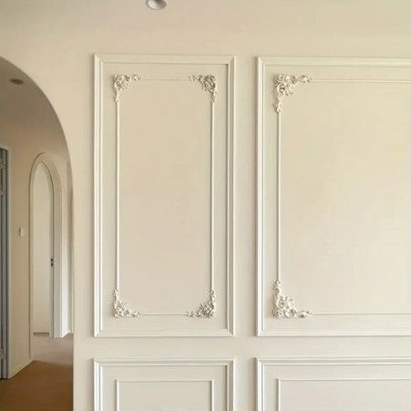 Walls painted in dusty blue and beige with limewash finish and gold-leaf mural art in a serene space.