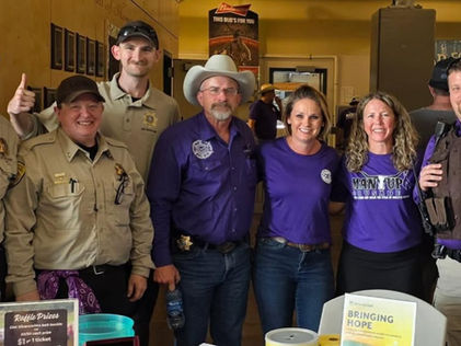 Staff from Lewis and Clark County Sheriff’s Office including Undersheriff Brent Colbert with immediate past Exchange Club President Coco Colbert and TFC’s Kim Patterson during Purple Night of the 2025 Last Chance Stampede