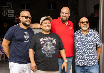 Four men smiling for a group photo