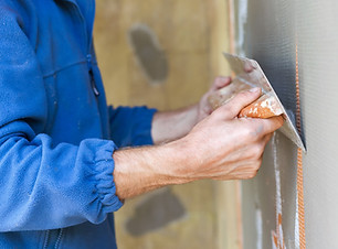 Construction worker with long trowel pla