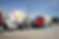 Red cement trucks With LOGO at a construction site.png