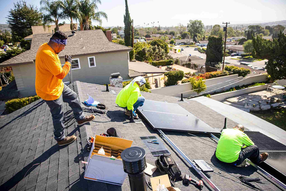 Solar installers working on a residential rooftop solar project in California