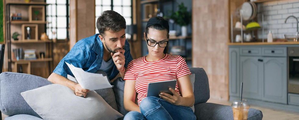 Couple reviewing costs and options before buying a Level 2 EV charger for home in 2026