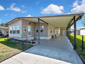 Covered parking carport beside a manufactured home residence