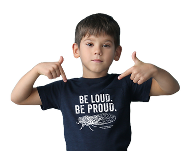 Young child wearing dark shirt that says be loud be proud