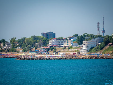A panoramic view of a seaside resort with hotels and apartments along the coast