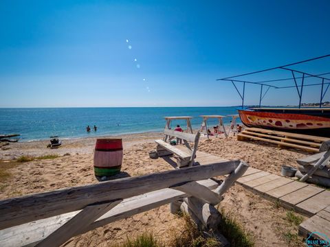 A wooden walkway leading to a beach
