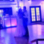 Eye-level view of DJ setup with speakers and mixing console