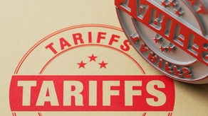 Red "TARIFFS" stamp on beige paper, partially pressed. Bold text and three stars highlighted. A logo with "Blog" in the top left.