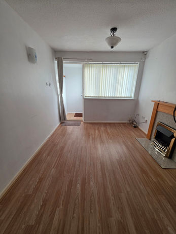 Lounge at the Beaumont Leys bungalow empty after the removal team completed loading.