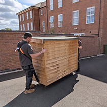 Leicester Moving Company team using lifting straps to move a shed safely.