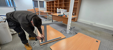 LMC dismantling office desk during office clearance in Leicester