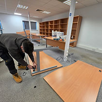 Leicester Moving Company team member dismantling an office desk during a commercial clearance in Leicester