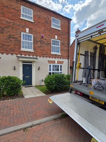 House removals team loading a van for a local move in Coalville