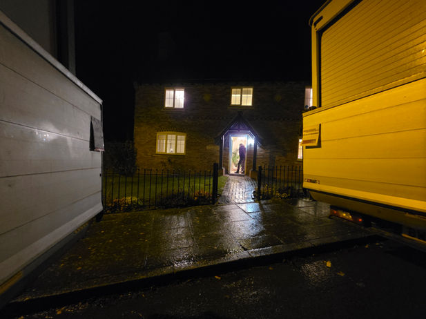 Two removal vans parked outside the new Burton Lazars property after unloading.
