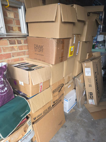 CD collection boxed and stacked in customer’s garage before removal.