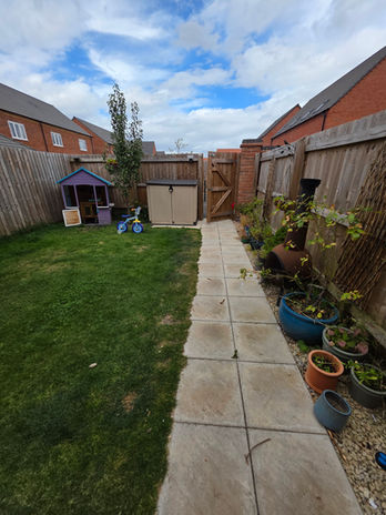 Garden area before packing outdoor items during New Lubbesthorpe house move.