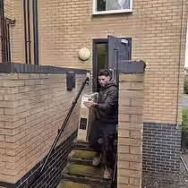 Mover carrying a TV box during a man and van job in Loughborough.