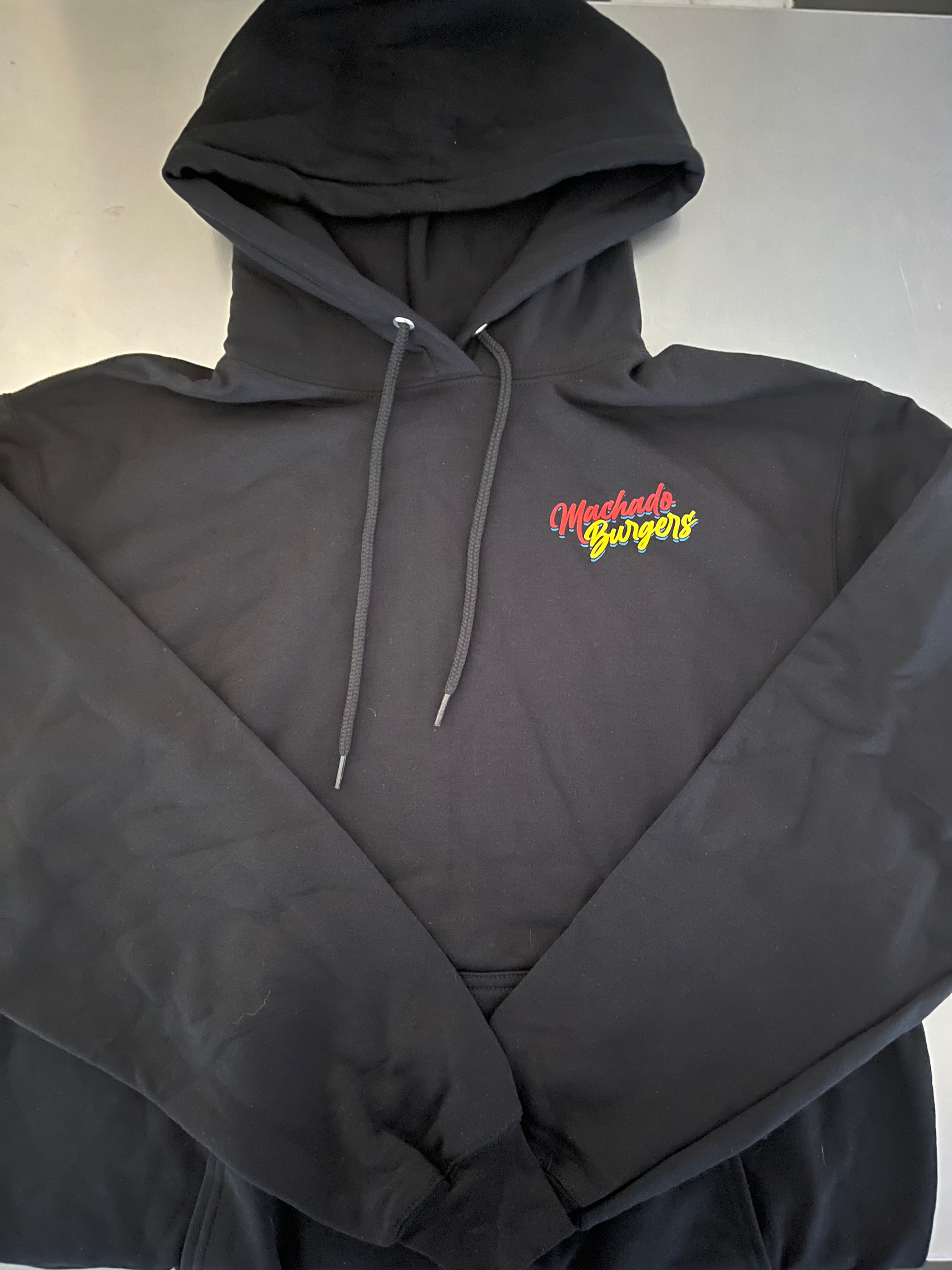 Black hoodie with "Off The Grid Supply" logo on a white surface.