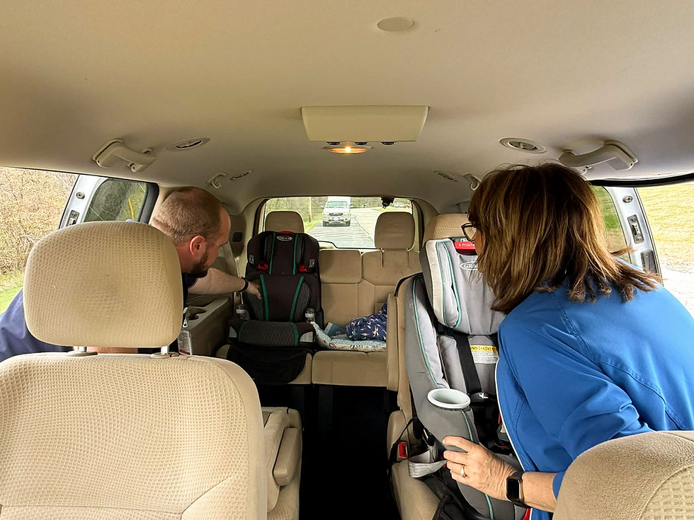 Zach Dunker, Certified Child Passenger Safety (CPS) Technician, inspects car seats for Kim Ruebke.