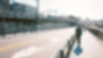 A professional man practicing active commuting by walking through a sunny city environment to his office, 2026 update.