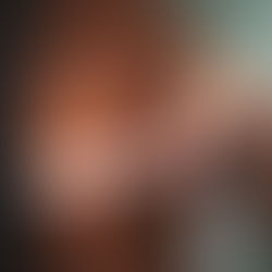 A person measures their chest with a white tape measure over a brown top.