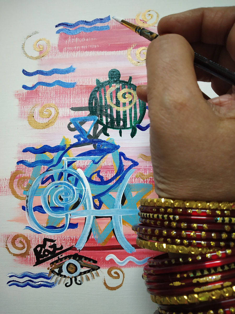 Thumbnail: Hand with bangles painting Pisces symbol and turtle